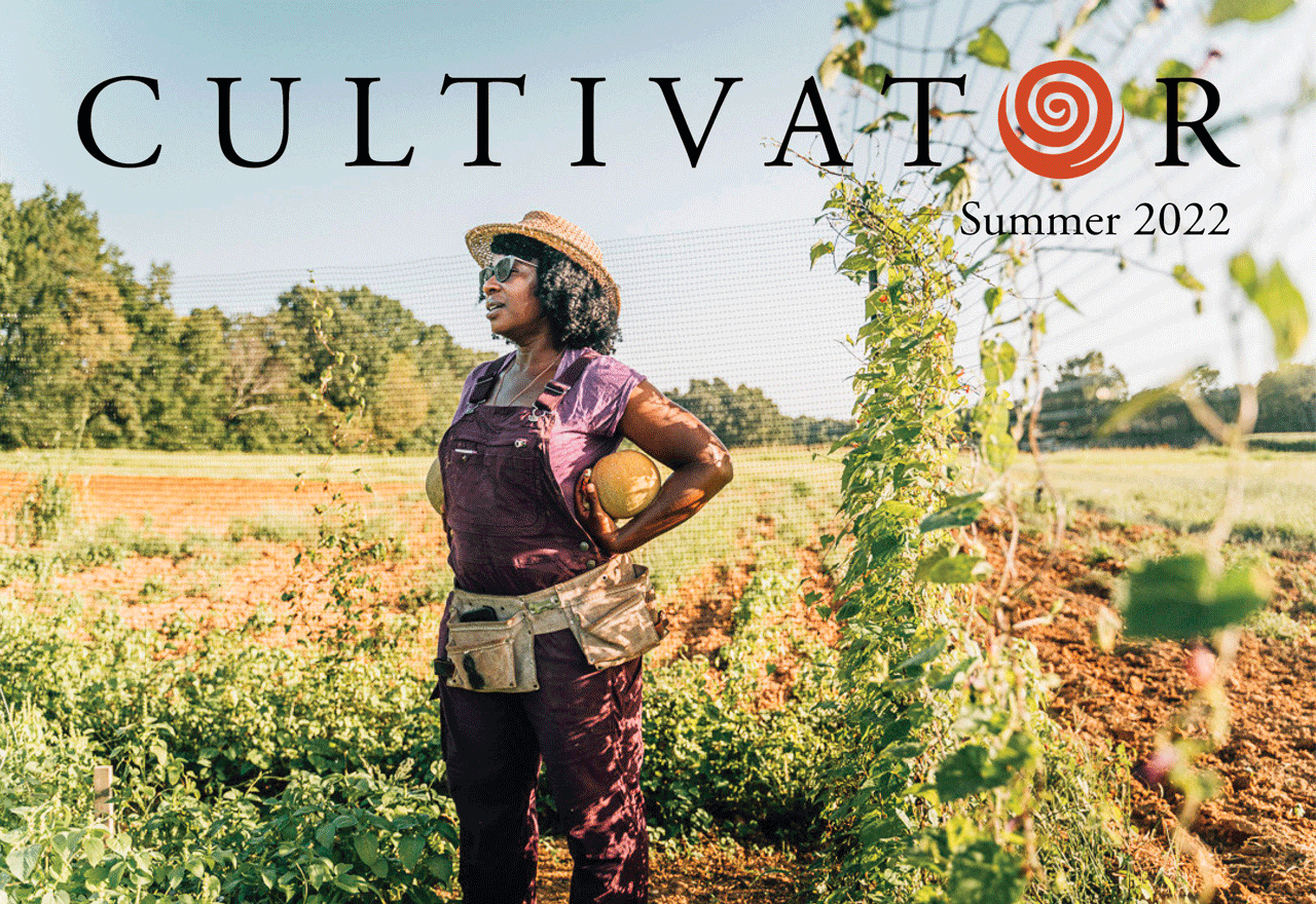 Farmer standing in field with a gourd in her hand