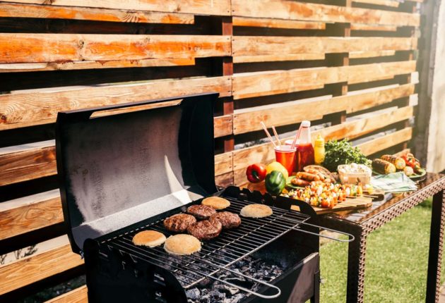 open grill with burgers cooking