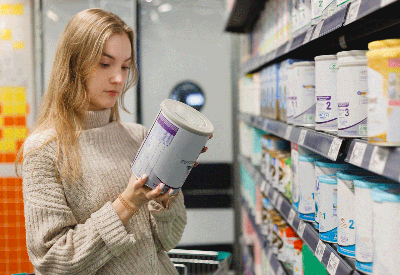 Woman reading an infant formula label