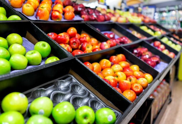 A variety of apples on a supermarket shelf