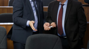 Two people in suits talking