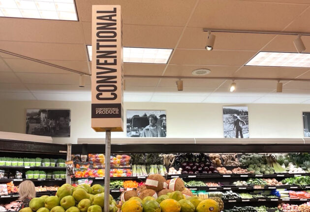 A produce section with a large sign that reads "conventional"