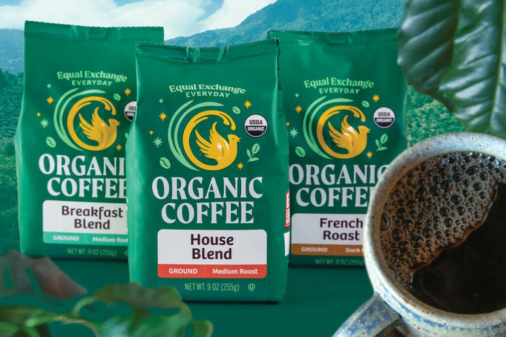 Three bags of Equal Exchange coffee and a mug of hot coffee